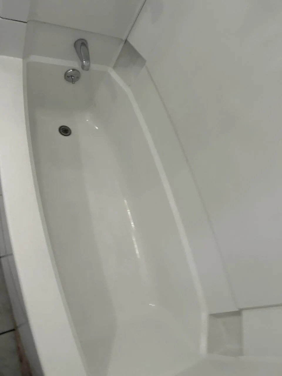 A clean white bathtub, after cleaning